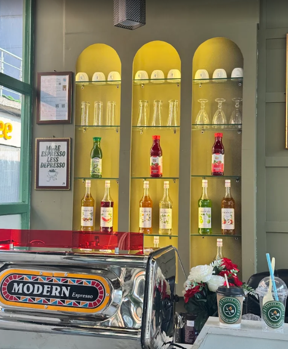 Espresso bar with syrup bottles and iced coffees